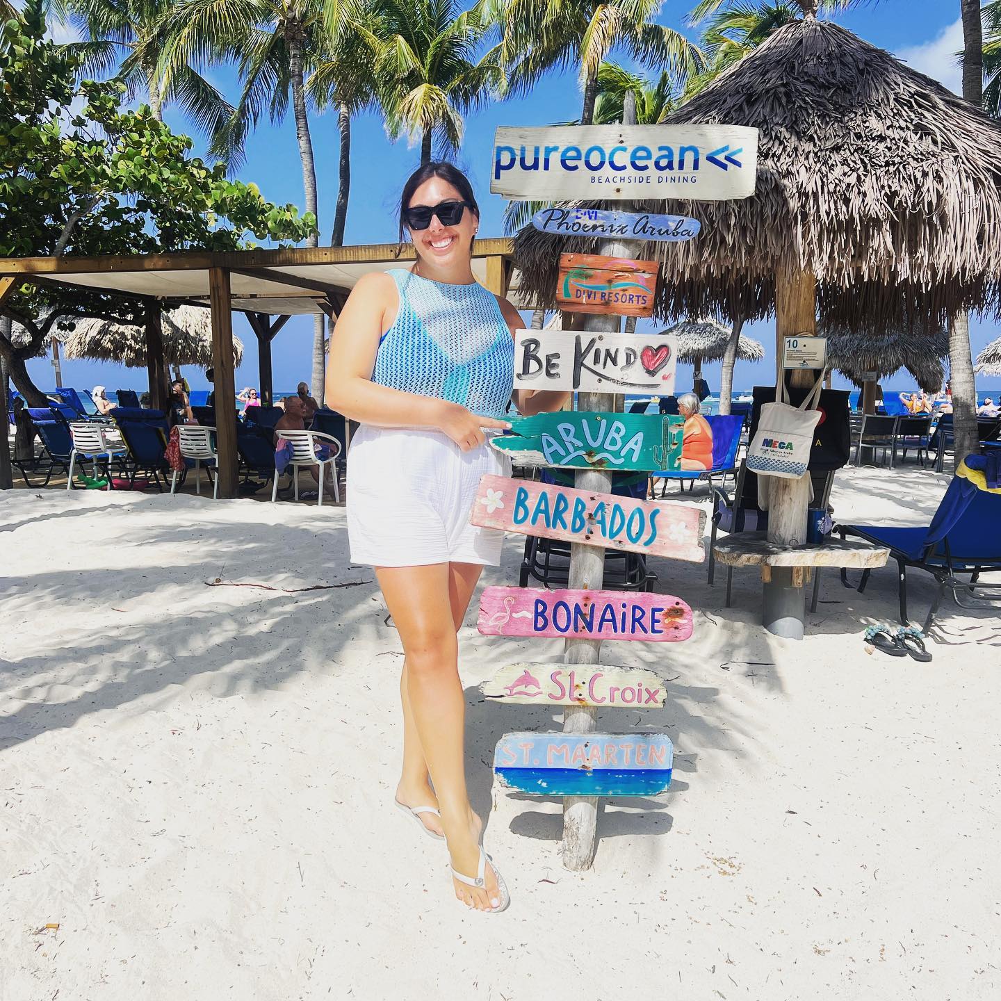 a woman standing in the sand with signs