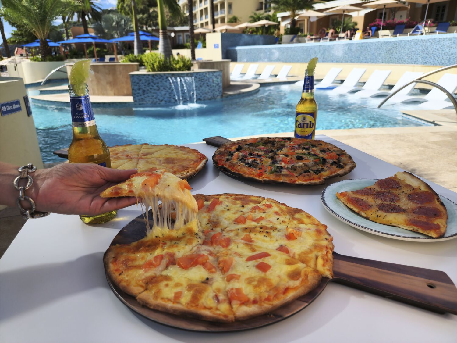 Slice pizzas and view of the pureocean pool behind it