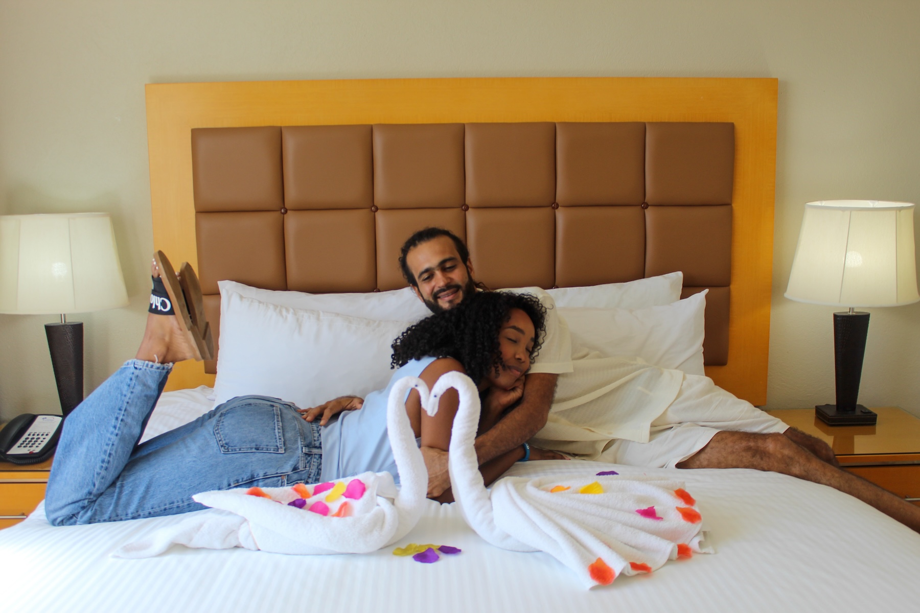 a man and woman lying on a bed