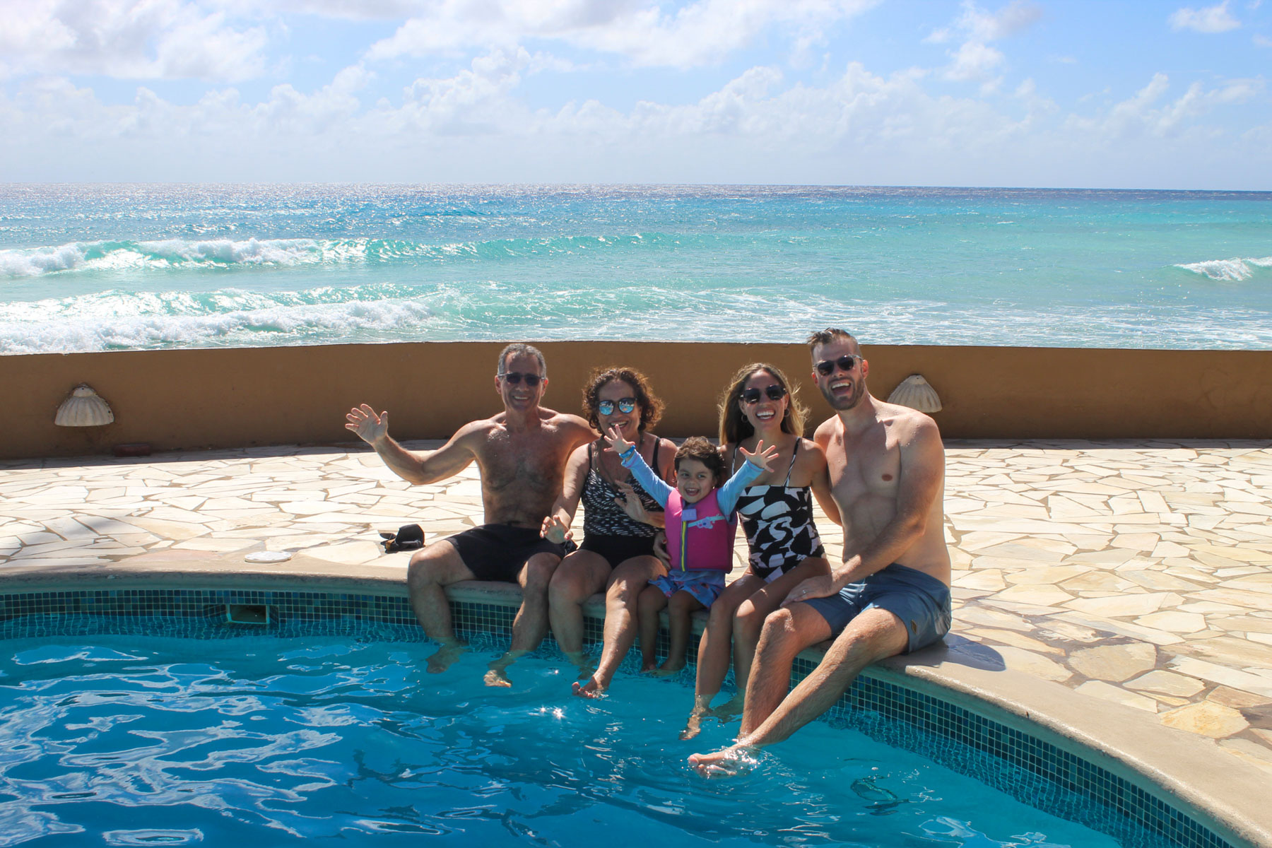 a group of people sitting on a pool